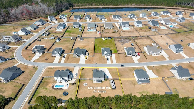 birds eye view of property featuring a residential view and a water view