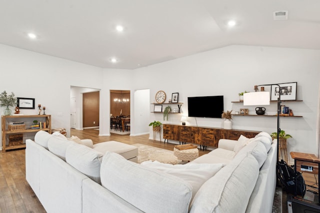 living room with hardwood / wood-style flooring and lofted ceiling