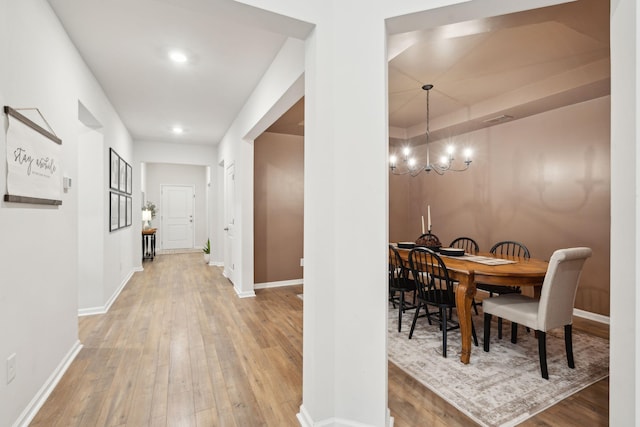 interior space featuring hardwood / wood-style flooring and an inviting chandelier