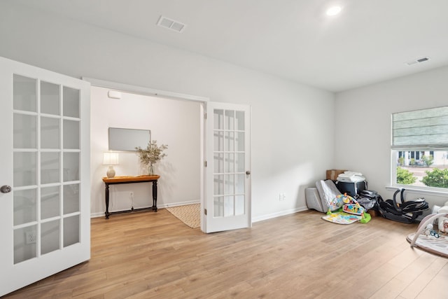 misc room featuring french doors and light hardwood / wood-style flooring