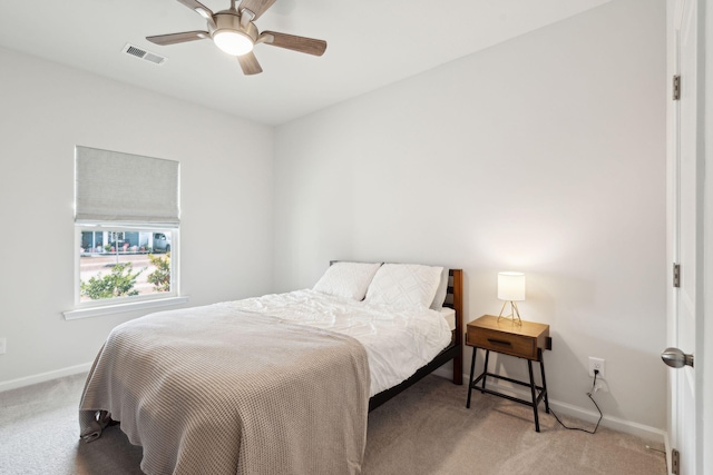 bedroom featuring ceiling fan and light carpet