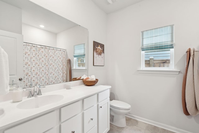 bathroom featuring vanity, toilet, and a wealth of natural light