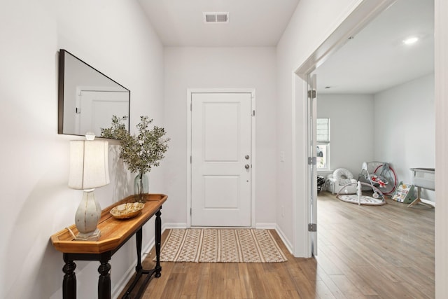 foyer entrance with light hardwood / wood-style floors