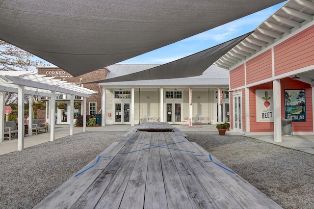 exterior space with a pergola and french doors