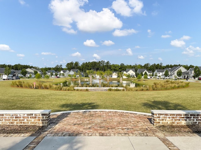 view of home's community with a yard and a water view