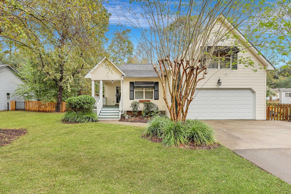 view of front of home with a garage and a front lawn