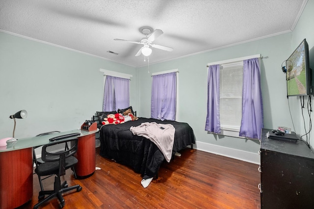 bedroom with a textured ceiling, ceiling fan, crown molding, and dark wood-type flooring