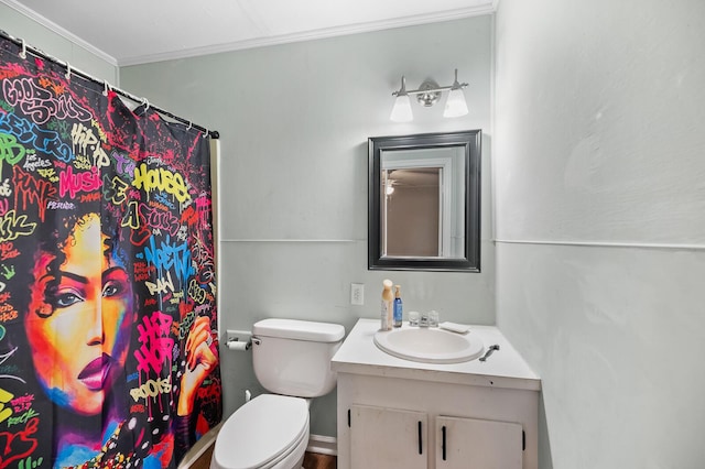 bathroom featuring vanity, toilet, and crown molding