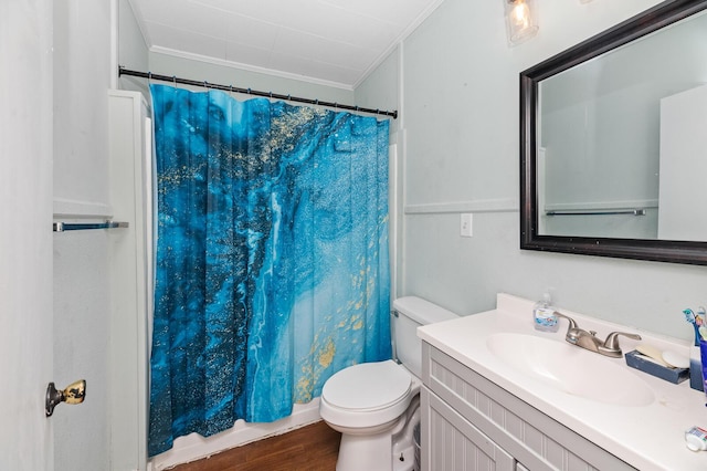 bathroom with crown molding, vanity, wood-type flooring, and toilet