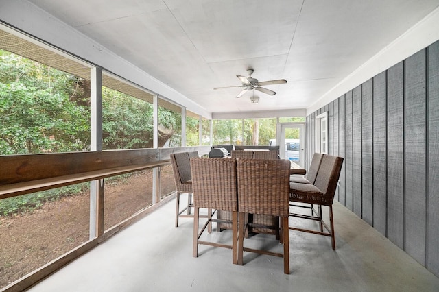 sunroom / solarium featuring ceiling fan