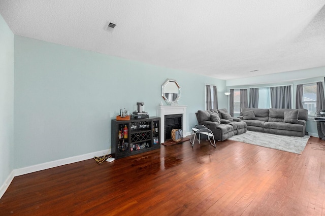 living room featuring hardwood / wood-style floors and a textured ceiling