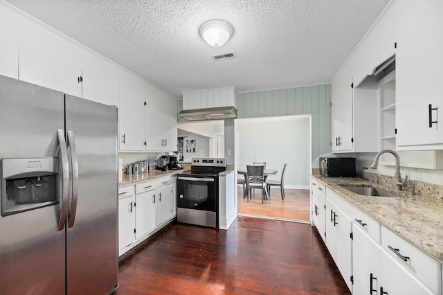 kitchen featuring white cabinetry, sink, light stone counters, dark hardwood / wood-style floors, and appliances with stainless steel finishes