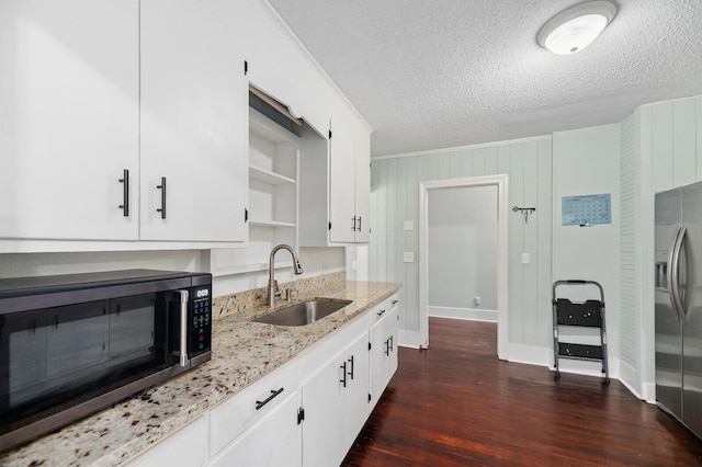 kitchen with white cabinets, dark hardwood / wood-style flooring, stainless steel appliances, and sink