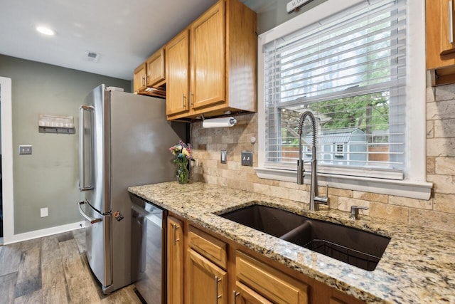 2158 Till Rd, Charleston, SC 29414 - kitchen featuring stainless steel appliances, light wood finished floors, tasteful backsplash, and light stone counters