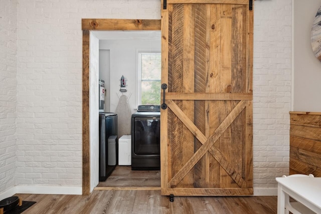 2158 Till Rd, Charleston, SC 29414 - detailed view of brick wall, washer and dryer, a barn door, and wood finished floors