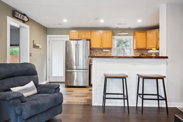 2158 Till Rd, Charleston, SC 29414 - kitchen featuring freestanding refrigerator, open floor plan, dark countertops, tasteful backsplash, and wood finished floors
