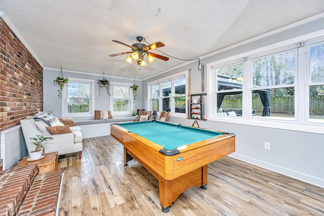 game room featuring ceiling fan, light hardwood / wood-style floors, ornamental molding, and billiards