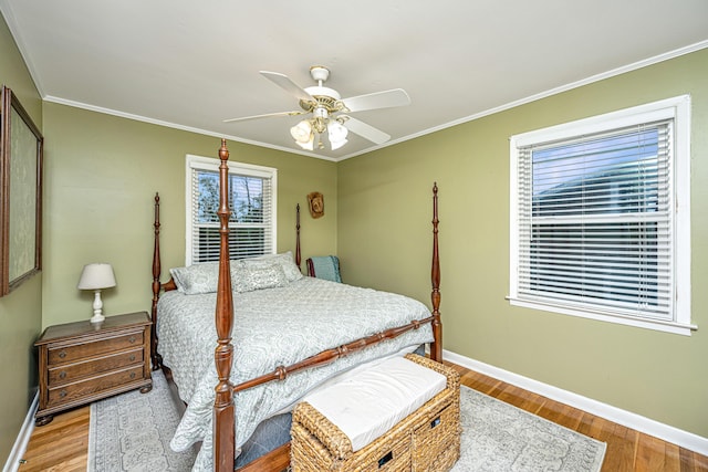 bedroom featuring wood-type flooring, ceiling fan, and crown molding