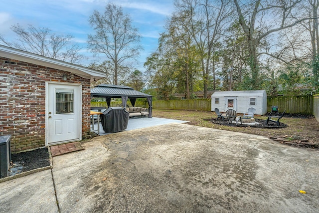 view of patio / terrace with a gazebo and an outbuilding