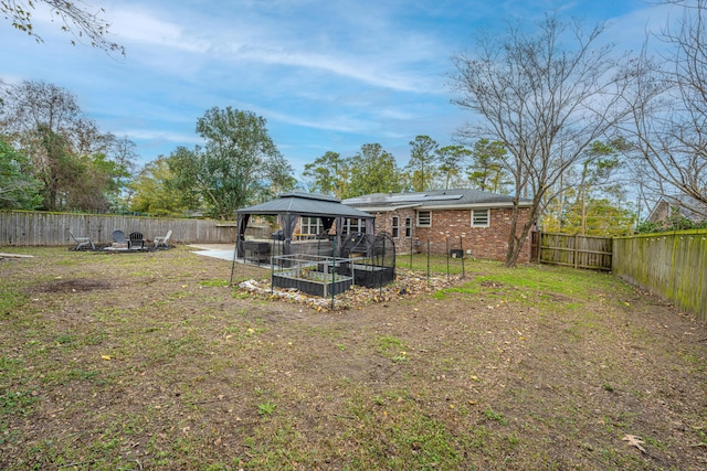 rear view of property with a gazebo