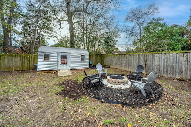 view of yard featuring an outbuilding and an outdoor fire pit