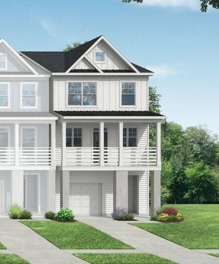 view of front of home featuring a front yard, an attached garage, board and batten siding, and driveway