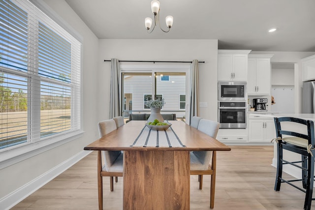 dining room with an inviting chandelier and light hardwood / wood-style floors