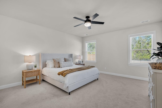 bedroom with light carpet and ceiling fan