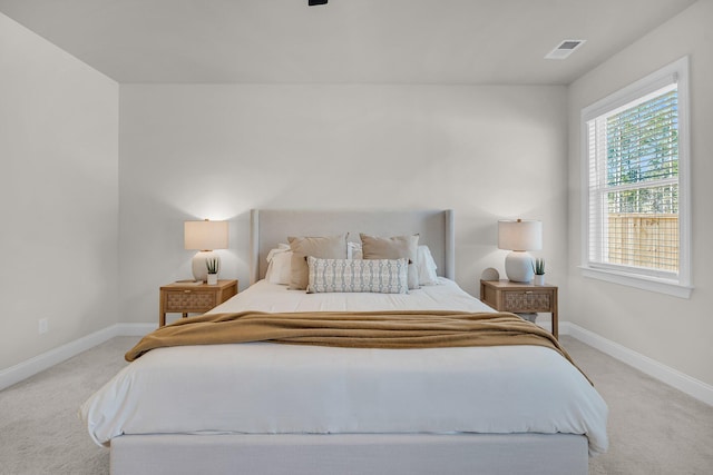 bedroom featuring light carpet