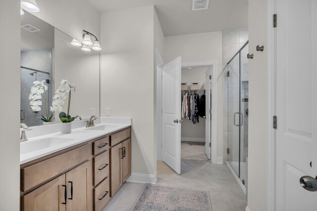 bathroom with vanity, tile patterned flooring, and walk in shower