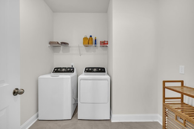 washroom with washer and dryer and light tile patterned flooring