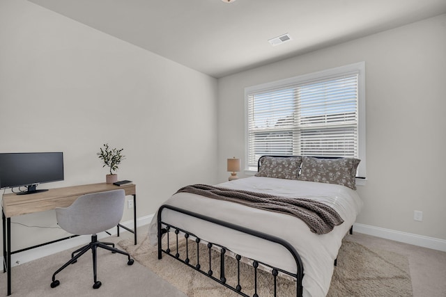 bedroom with light colored carpet