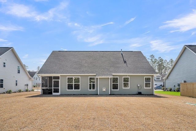 back of property with a sunroom