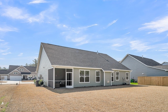 back of property with a sunroom