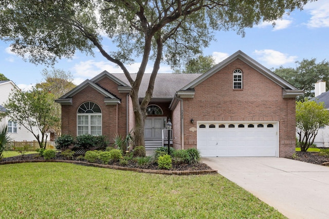 view of front of house featuring a garage and a front yard