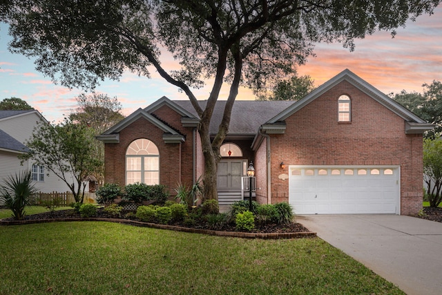 view of front of house featuring a garage and a yard