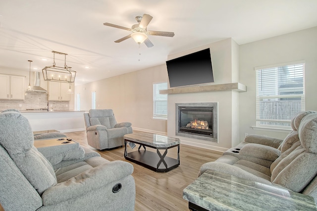 299 Lucca Dr, Summerville, SC 29486 - living area featuring ceiling fan, a glass covered fireplace, and light wood-style flooring