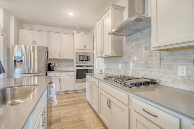 299 Lucca Dr, Summerville, SC 29486 - kitchen featuring wall chimney range hood, appliances with stainless steel finishes, backsplash, white cabinets, and light countertops