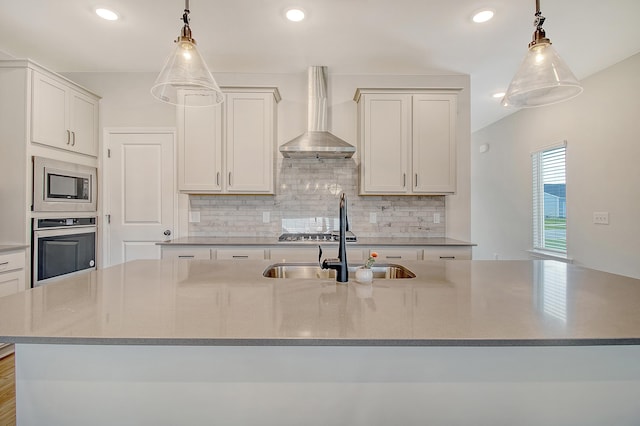 299 Lucca Dr, Summerville, SC 29486 - kitchen with stainless steel appliances, wall chimney exhaust hood, decorative backsplash, a kitchen island with sink, and pendant lighting