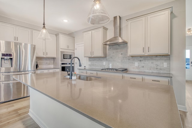 299 Lucca Dr, Summerville, SC 29486 - kitchen with stainless steel appliances, wall chimney exhaust hood, backsplash, an island with sink, and light countertops