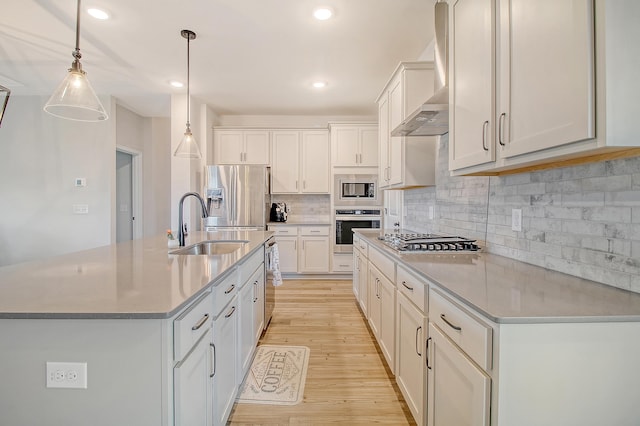 299 Lucca Dr, Summerville, SC 29486 - kitchen with stainless steel appliances, light wood-type flooring, wall chimney range hood, decorative backsplash, and white cabinets