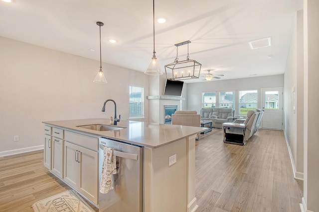 299 Lucca Dr, Summerville, SC 29486 - kitchen featuring stainless steel dishwasher, a fireplace, light wood-style flooring, white cabinetry, and ceiling fan