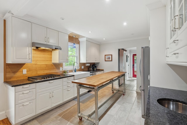 293 Grove St, Charleston, SC 29403 - kitchen with appliances with stainless steel finishes, a sink, tasteful backsplash, white cabinets, and crown molding