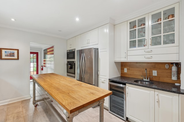 293 Grove St, Charleston, SC 29403 - kitchen with beverage cooler, freestanding refrigerator, a sink, white cabinetry, and crown molding
