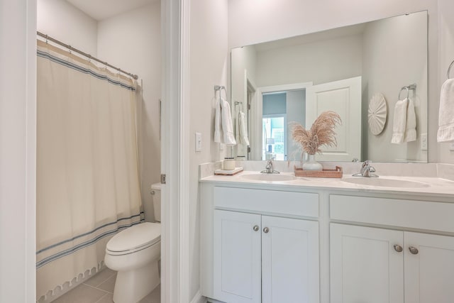 bathroom featuring tile patterned floors, vanity, and toilet