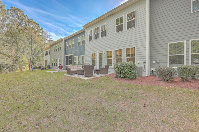 back of house with a yard, an outdoor hangout area, and a patio