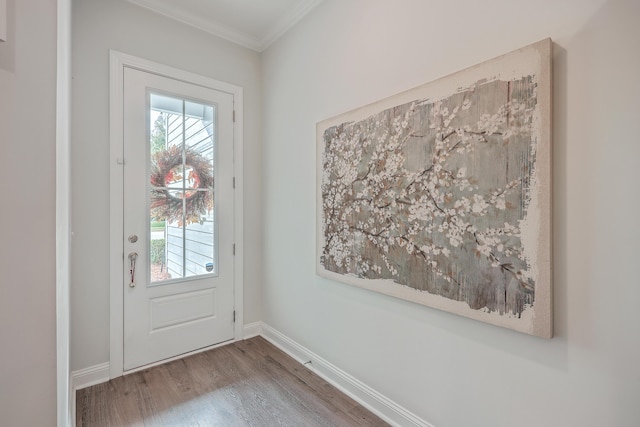 entryway with hardwood / wood-style floors and ornamental molding