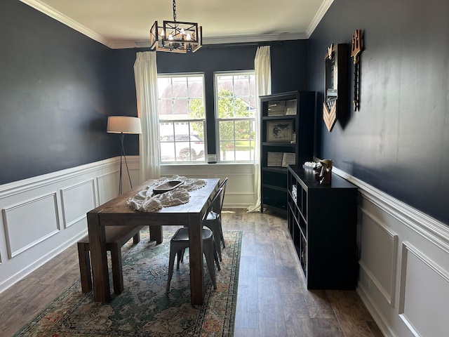 677 Redbud Ln, Summerville, SC 29486 - dining room featuring a decorative wall, a chandelier, dark wood finished floors, a wainscoted wall, and ornamental molding