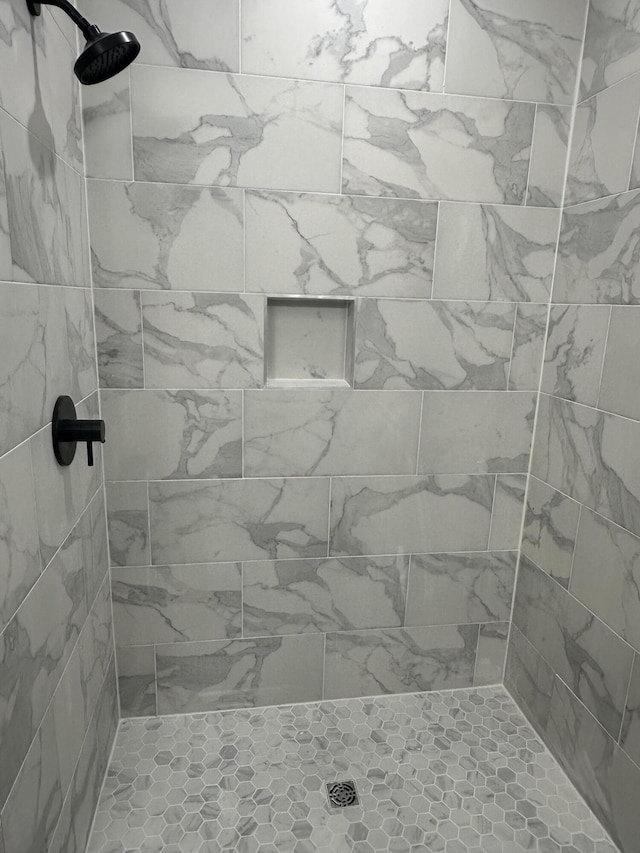 bathroom with a tile shower