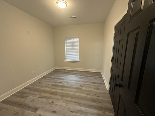 unfurnished room with hardwood / wood-style flooring